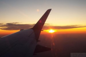 sun through clouds high altitude embraer 170 polish airlines.JPG