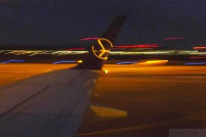 waw night chopin airport colourful lights lot polish airlines logo.JPG