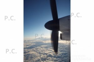 Bombardier over clouds shining sun spinner