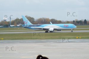 tui pony tail white blue navy blue painting resembling waves on fuselage